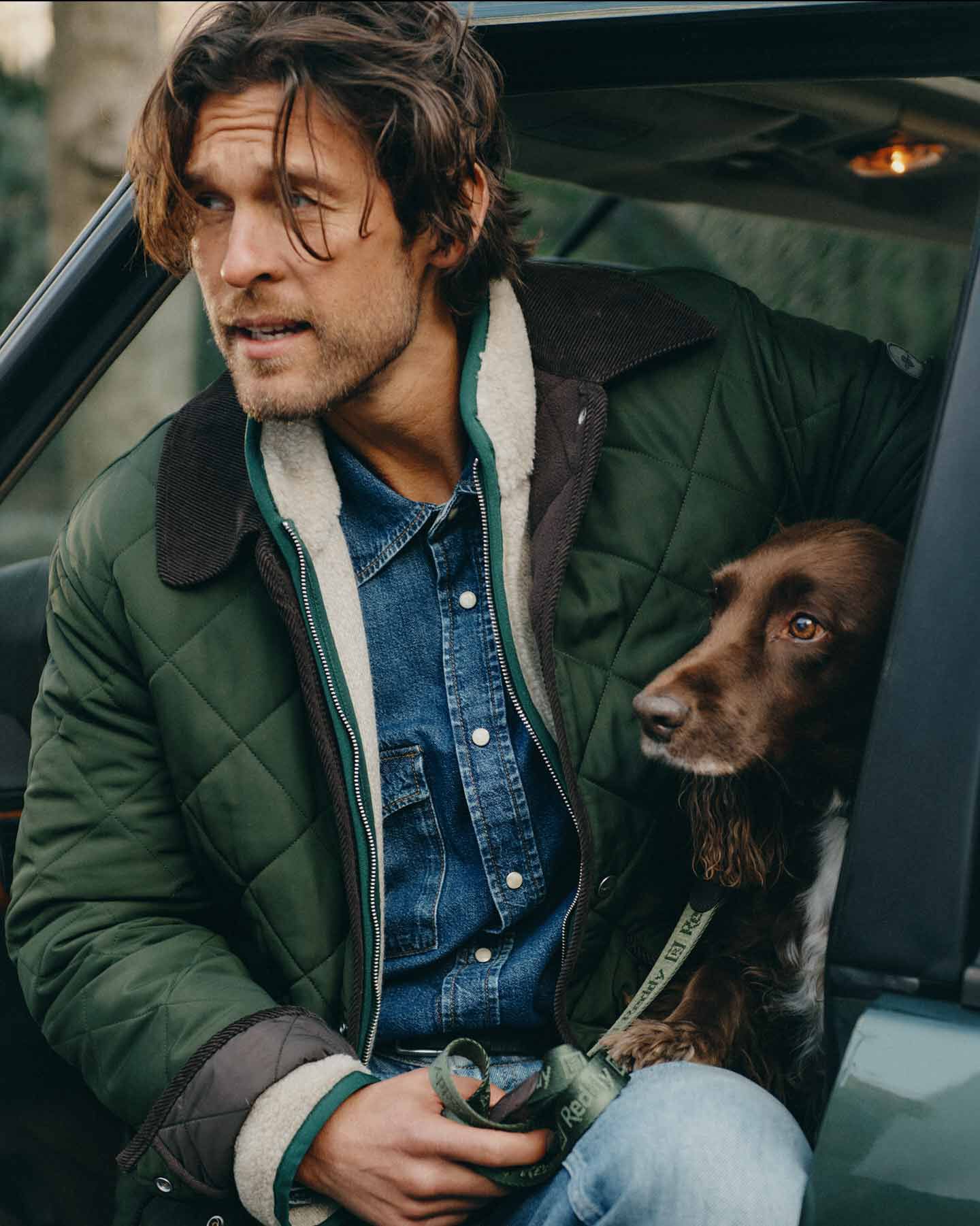 Man in green Gant quilted jacket stepping out of a car